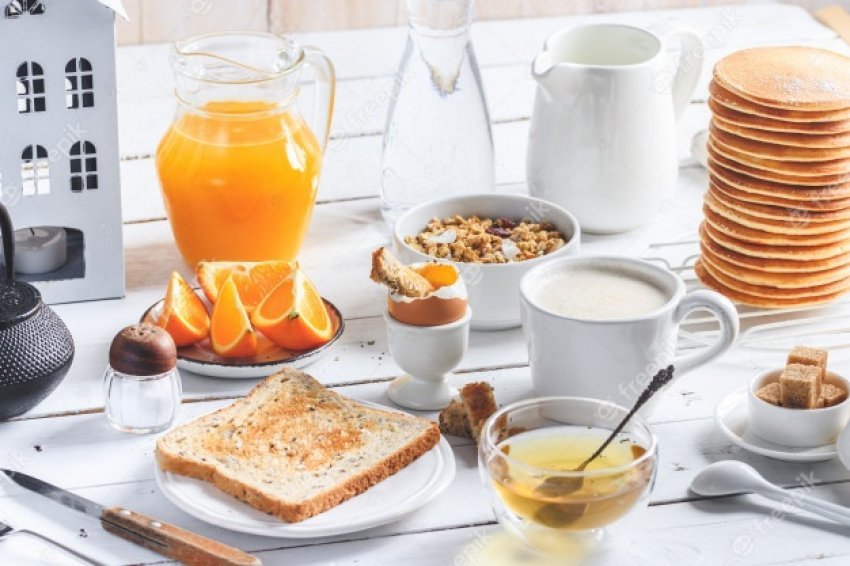 auto_pancakes-soft-boiled-egg-toast-oatmeal-granola-fruit-coffee-tea-orange-juice-milk-white-wood_147970-131630731884