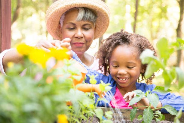 grandmother-and-child-gardening-outdoors-in-spring