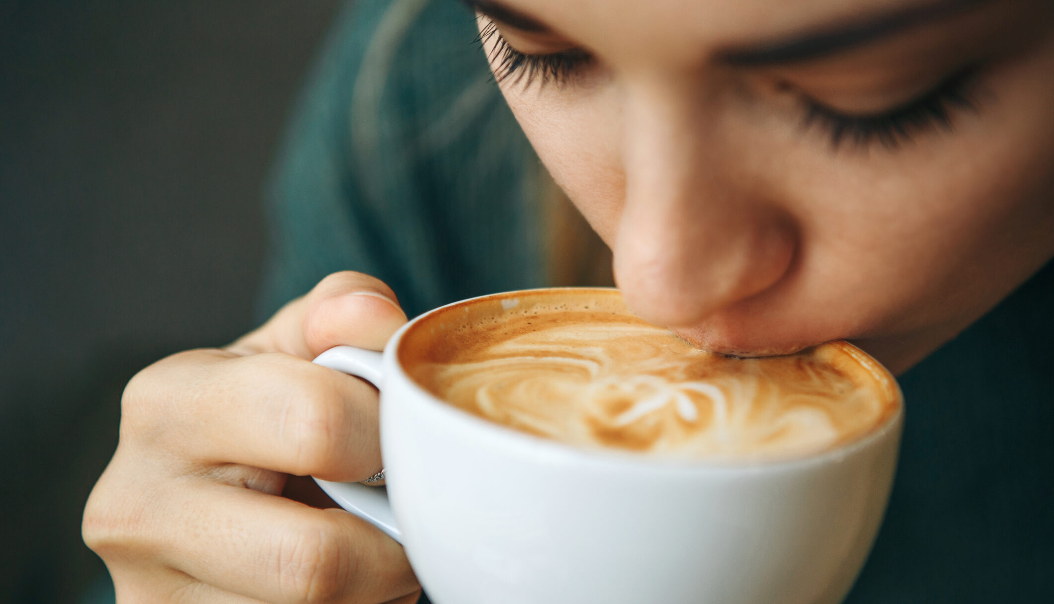 Close up girl is drinking coffee